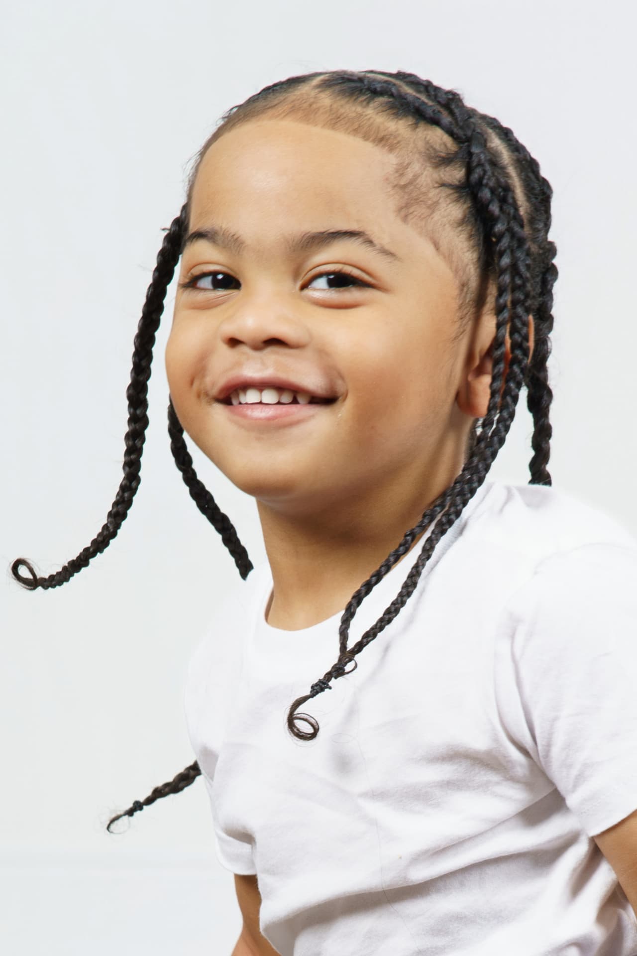 Close-up studio portrait of twin boy smiling